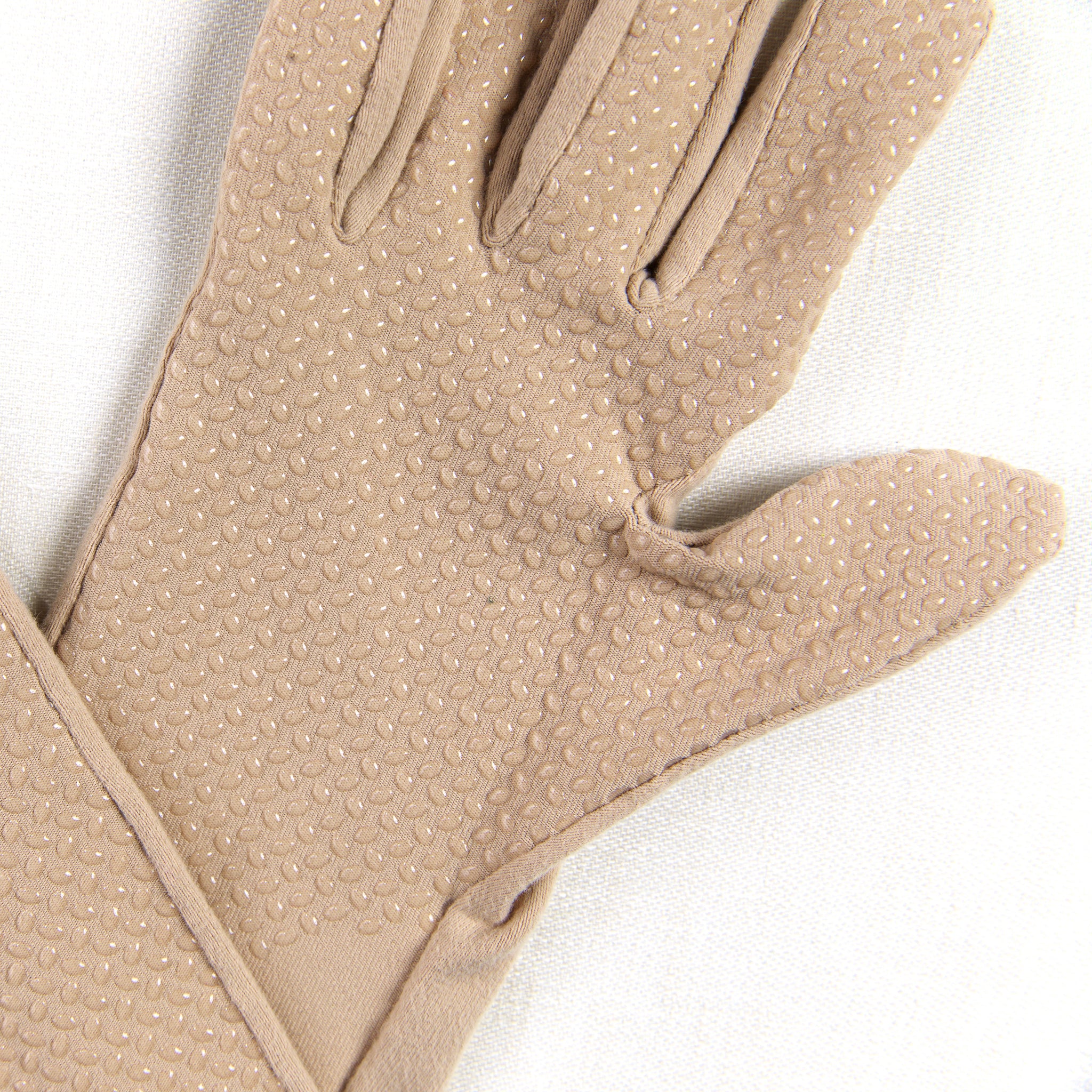 Beige glove with textured palm on a white background