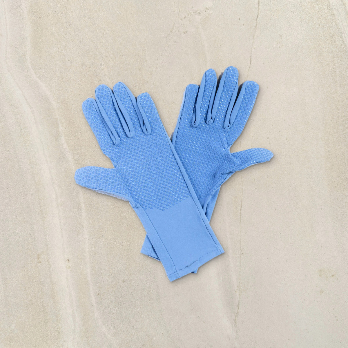 higarden mid rise gardening gloves in dewdrop blue showing the grip palms, flat lay on limestone