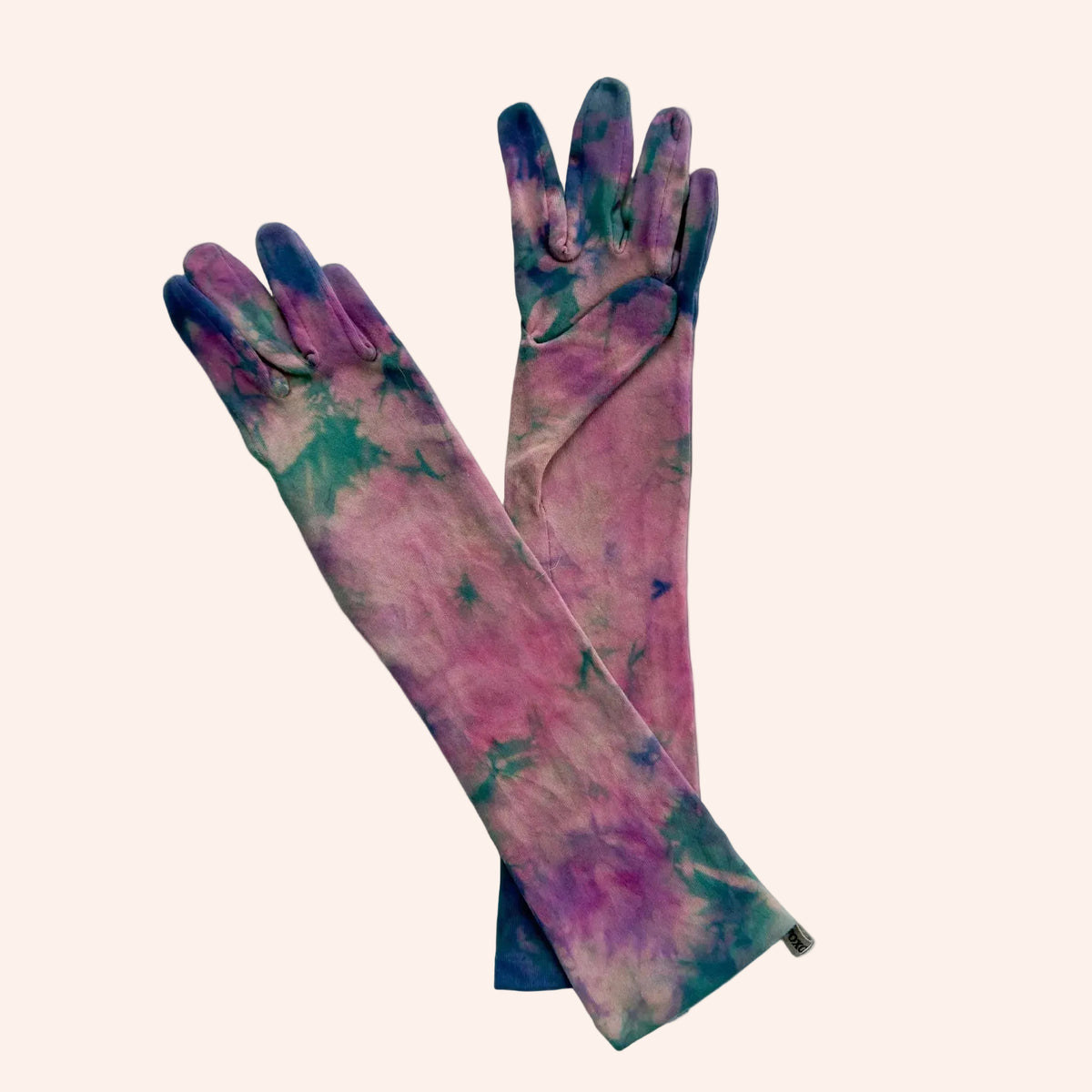 A pair of long gloves with a tie-dye pattern in pink, purple, and teal, displayed against a solid white background.