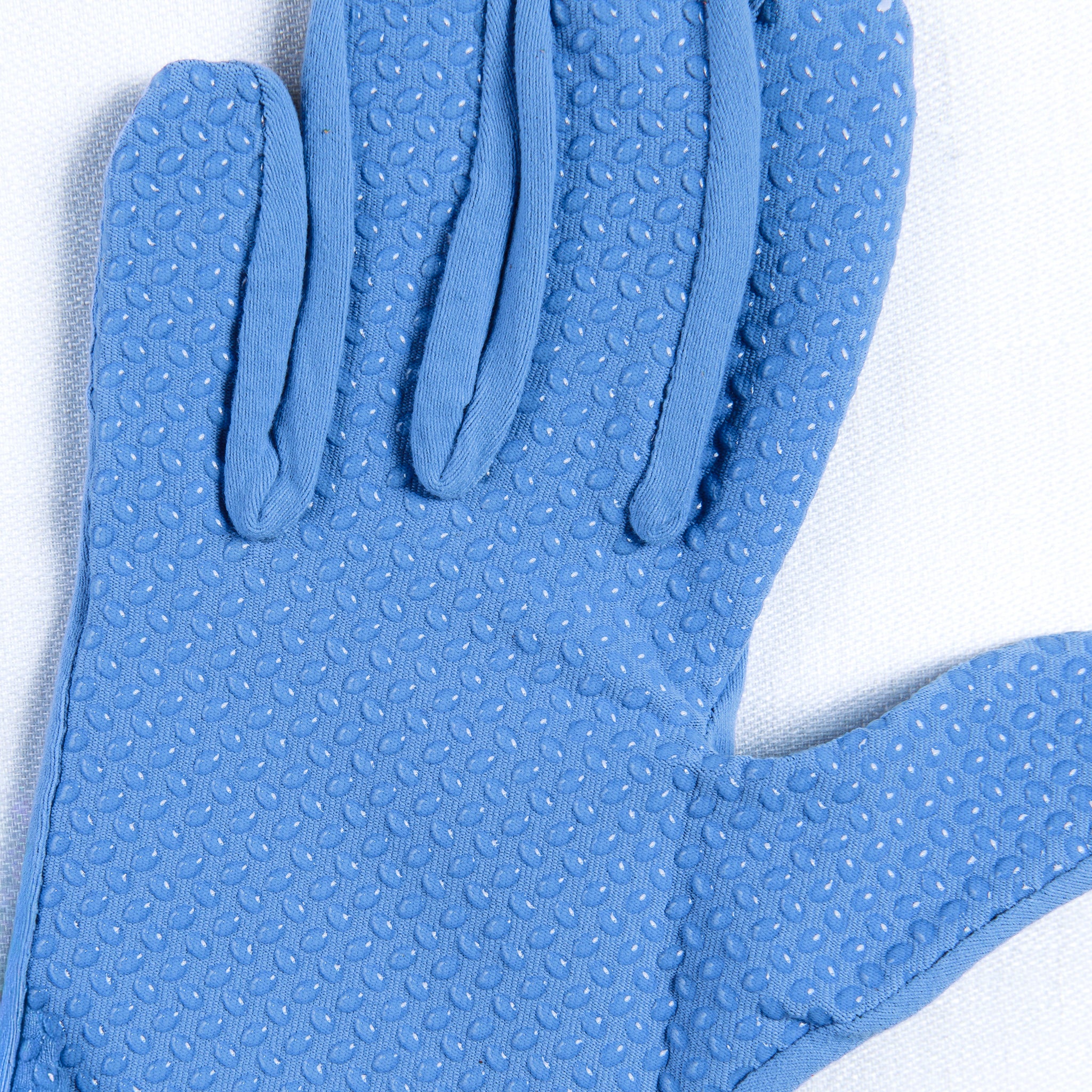 Close-up of a blue textured glove on a white background