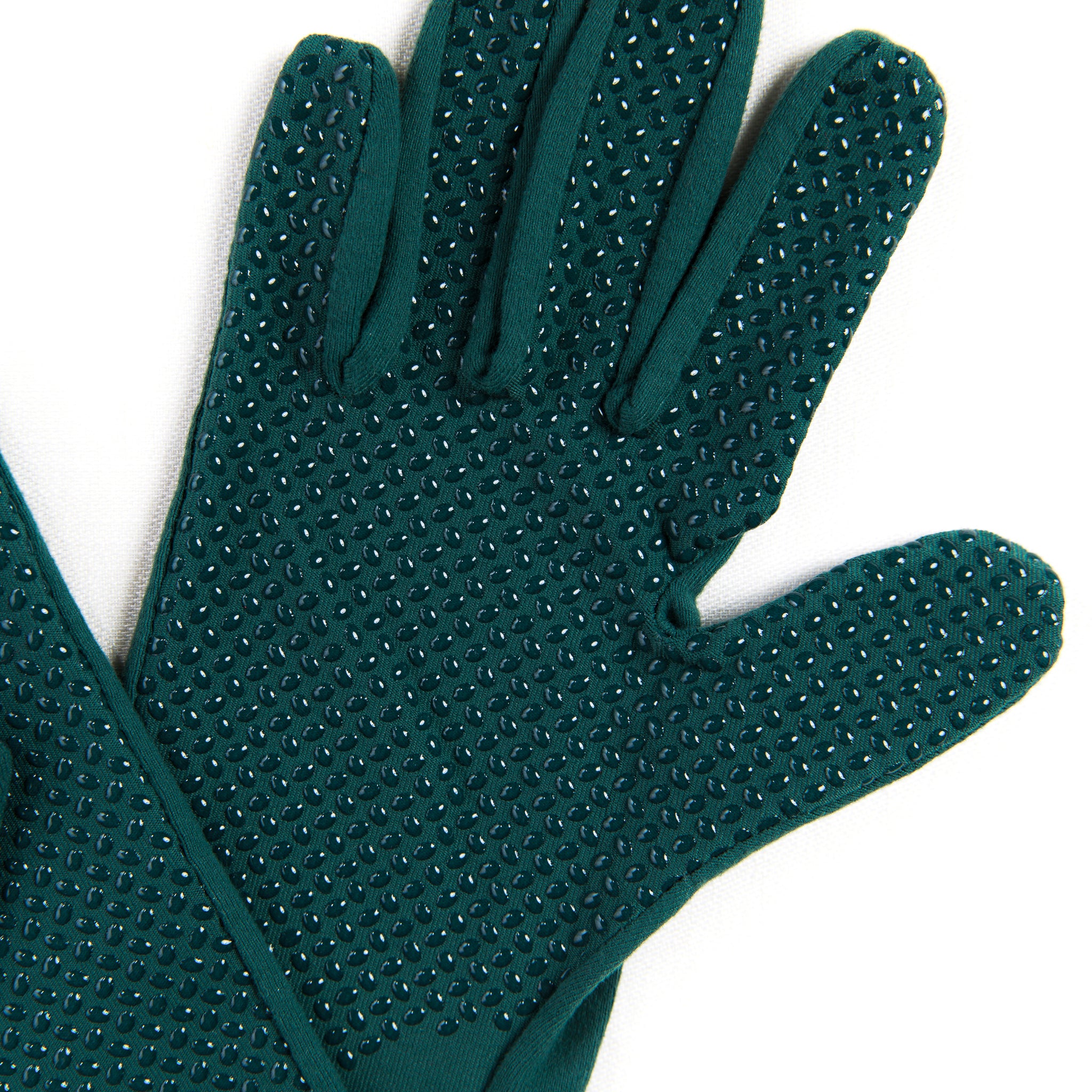 Pair of green massage gloves with textured surface on a white background