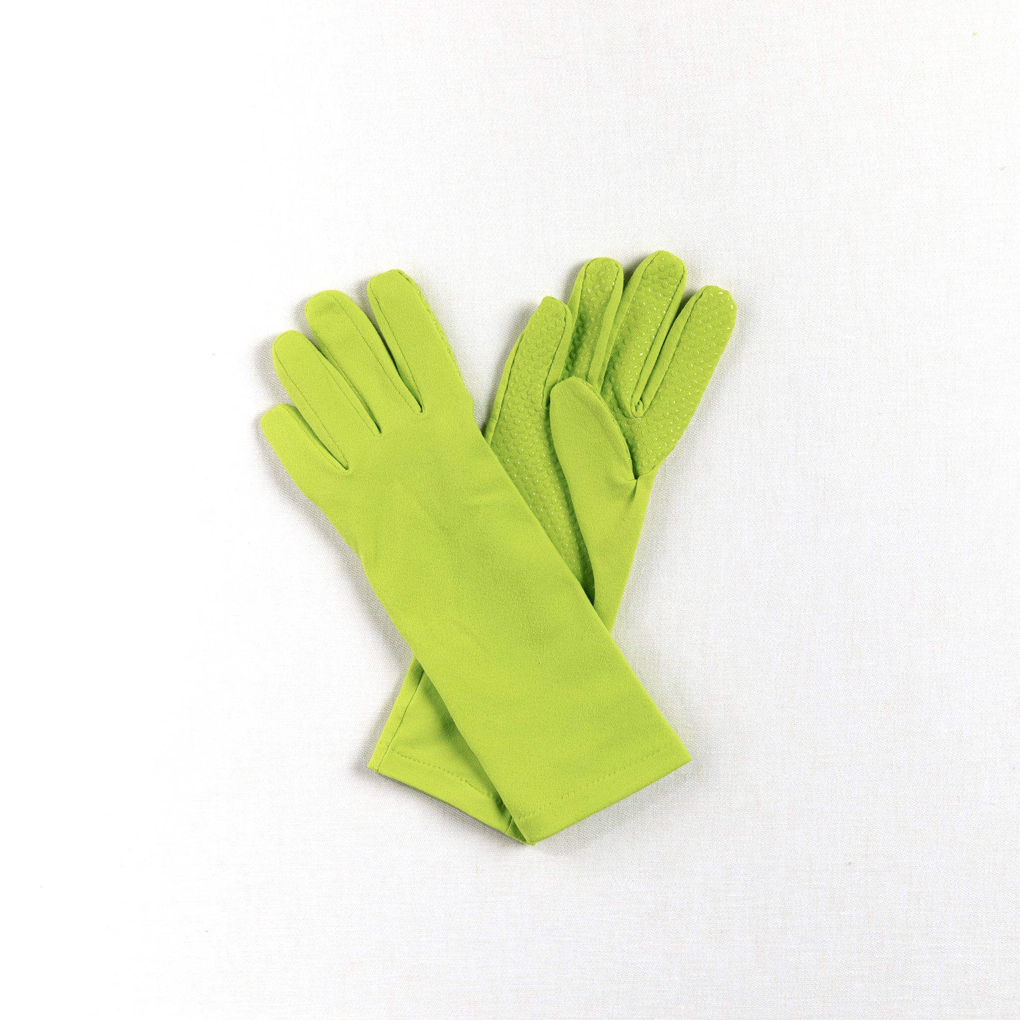 Pair of green womens gardening gloves with grip palm on a white background