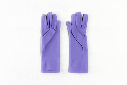 Pair of purple gloves on a white background Pair of lavender womens gardening gloves with smooth palm on a white background