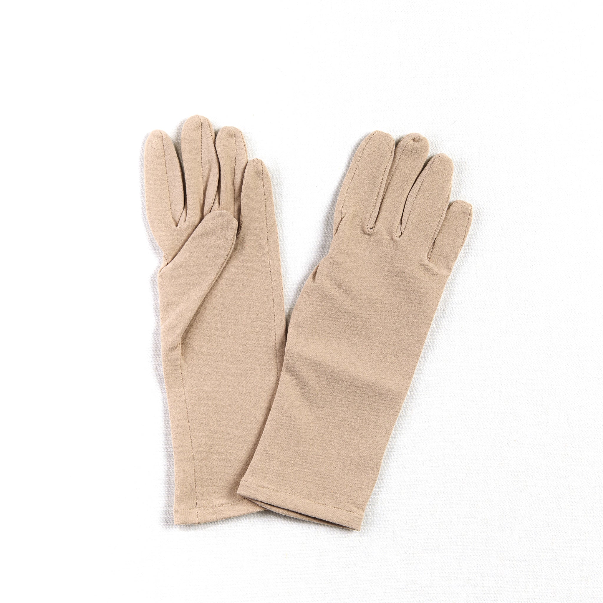 Pair of skin color gloves, beige tight womens gloves with smooth palm on a white background