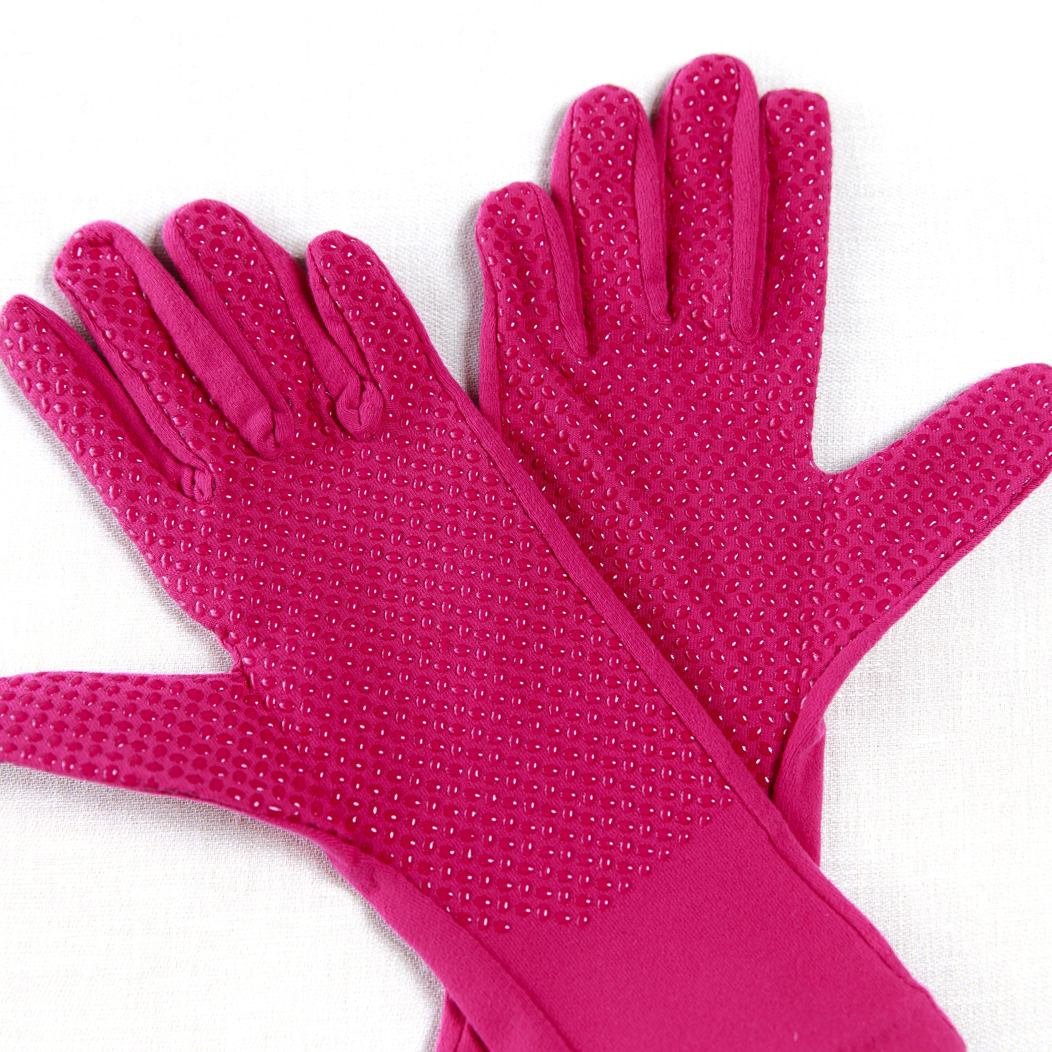 Pair of hot barbie pink gloves with textured palm on a white background