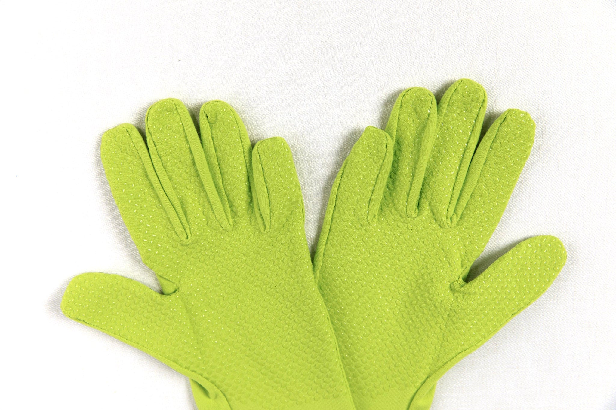 Pair of green higarden heritage gardening gloves on a white background