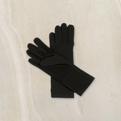 higarden mid rise gardening gloves in black showing the grip palm, flat lay on limestone