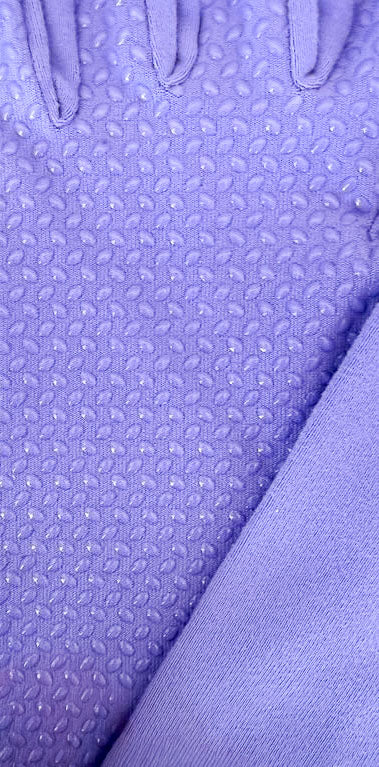 Close-up of purple textured fabric with a pattern of silicone dots on the palm of a glove.